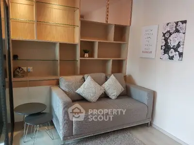 Cozy living room with modern sofa and stylish shelving in a contemporary apartment.