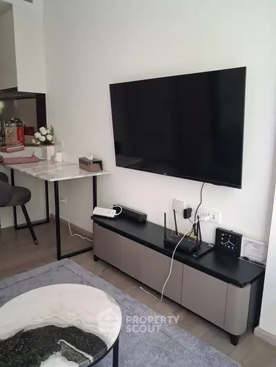 Modern living room with wall-mounted TV and stylish furniture