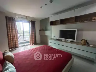 Modern bedroom with balcony access and stylish built-in storage