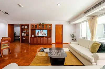 Spacious living room with modern furniture and large windows for natural light.