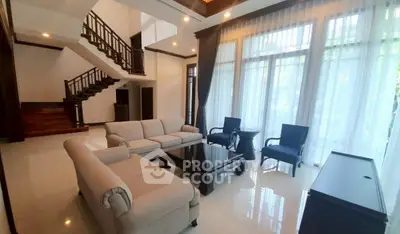 Luxurious living room with elegant furniture and large windows