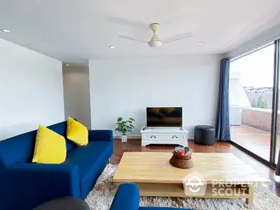 Spacious living room with modern decor and large balcony access