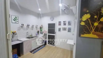 Charming kitchen with modern decor and open layout, featuring wall art and ample lighting.