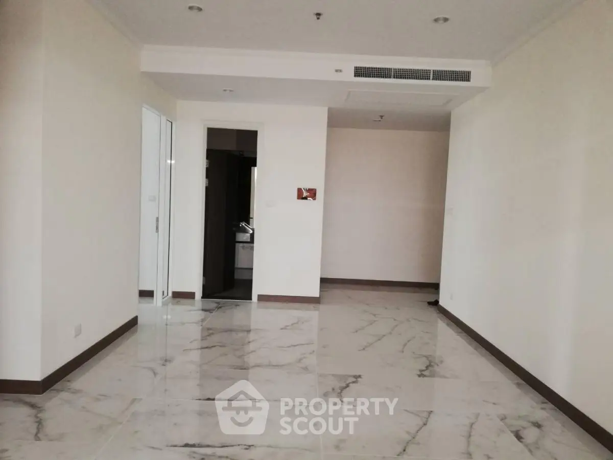 Spacious modern interior with marble flooring and neutral walls, ideal for customization.