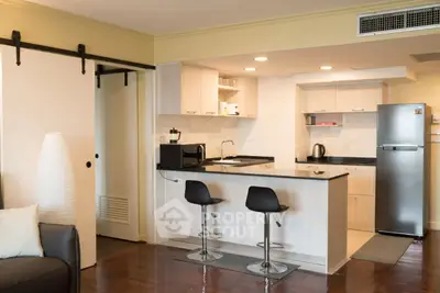 Modern kitchen with sleek design, featuring an open layout and stylish bar seating, perfect for entertaining.