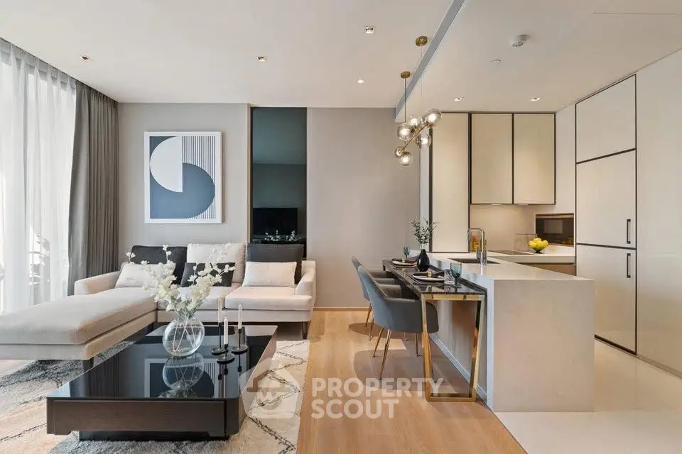 Modern open-plan living room with elegant decor and sleek kitchen design.