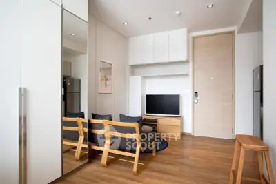 Modern living room with wooden flooring and sleek furniture in a stylish apartment.