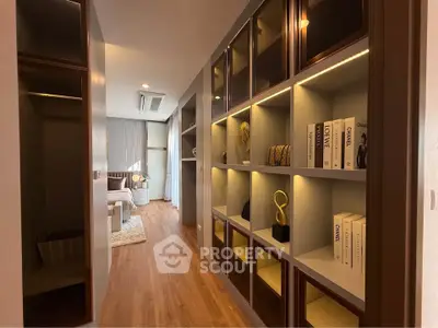 Modern apartment hallway with stylish shelving and cozy living area