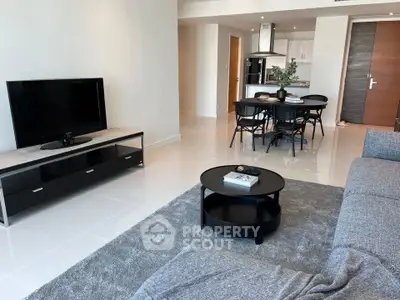 Modern living room with sleek furniture and open kitchen layout, perfect for contemporary living.