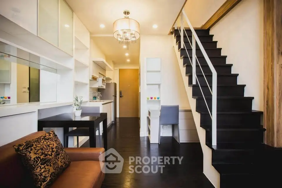 Modern duplex apartment with stylish staircase and open living area, perfect for urban living.