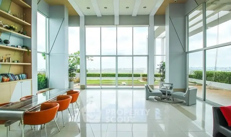 Luxurious modern living room with floor-to-ceiling windows and stunning ocean view.