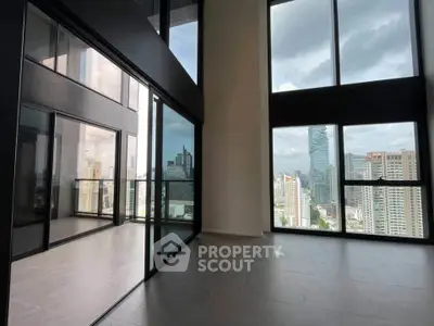 Stunning high-rise apartment with floor-to-ceiling windows and breathtaking city views.