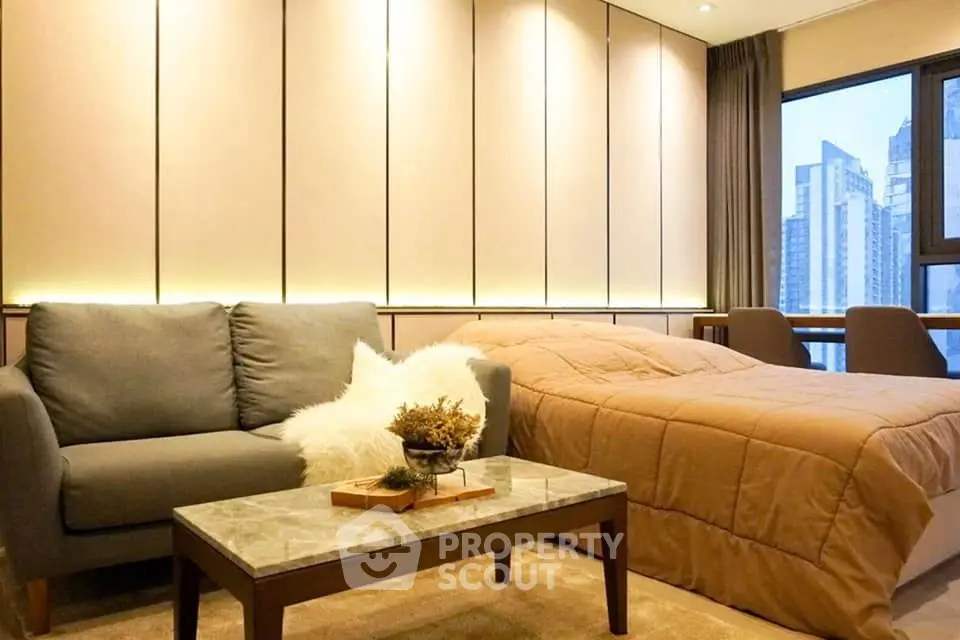 Modern studio apartment with cozy living area and city view