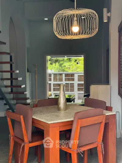 Chic dining area with modern lighting and stylish wooden furniture