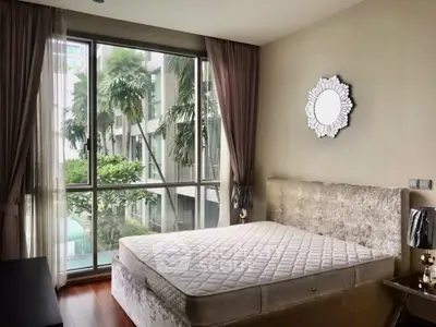 Luxurious bedroom with large window and elegant decor in modern apartment