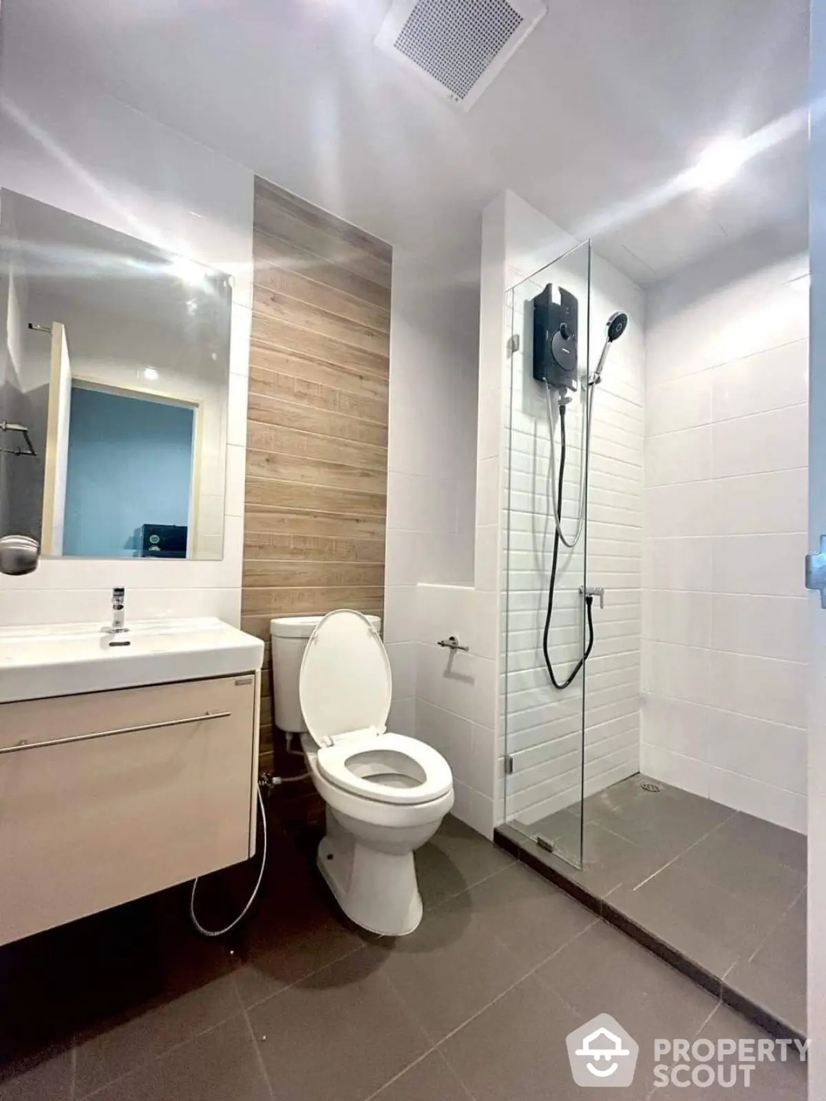 Modern bathroom with glass shower and sleek vanity in contemporary apartment