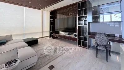 Luxurious modern living room with sleek design and large TV, perfect for entertainment and relaxation.