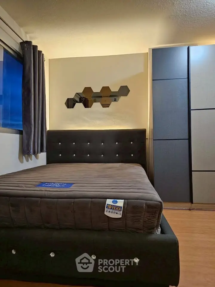 Modern bedroom with stylish decor and comfortable bed in a cozy apartment.