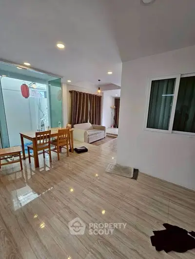Spacious open-plan living and dining area with modern decor and natural light.