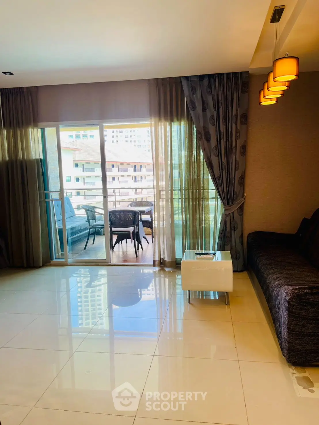 Spacious modern living room with large windows offering abundant natural light and a stunning view.