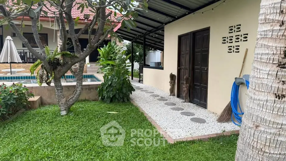 Charming garden view with poolside and lush greenery in a serene residential setting.