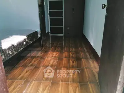 Cozy bedroom with wooden flooring and minimalist furniture