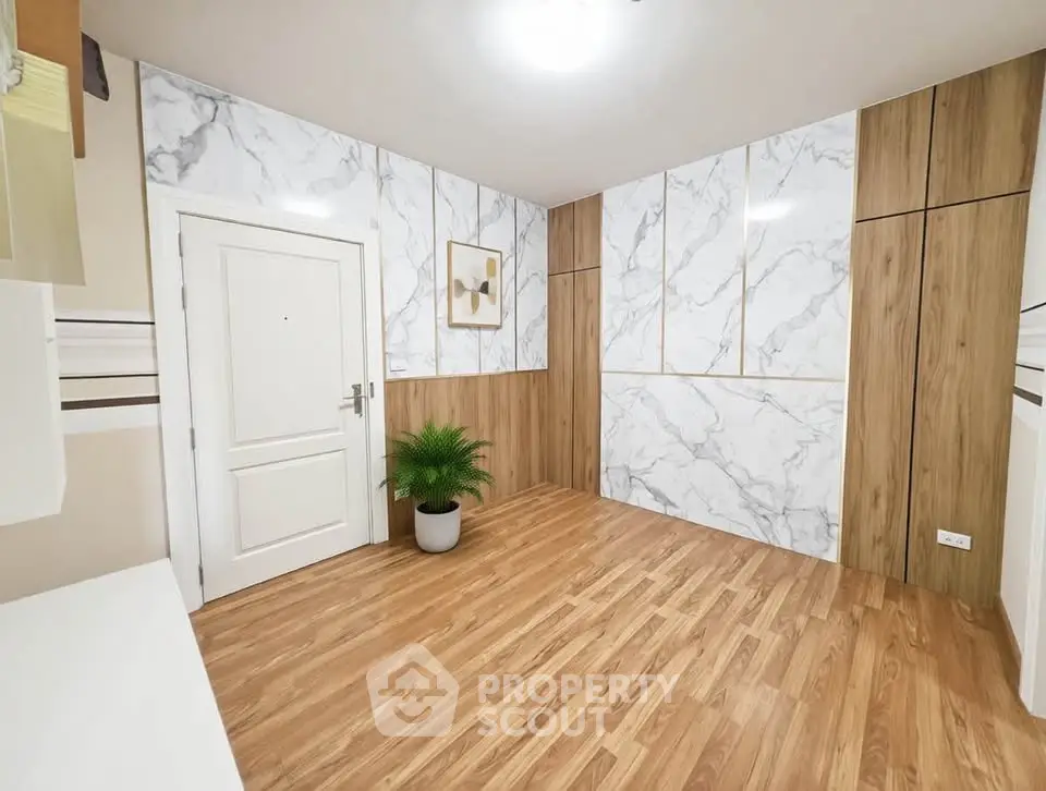 Elegant modern interior with wood flooring and marble accent walls