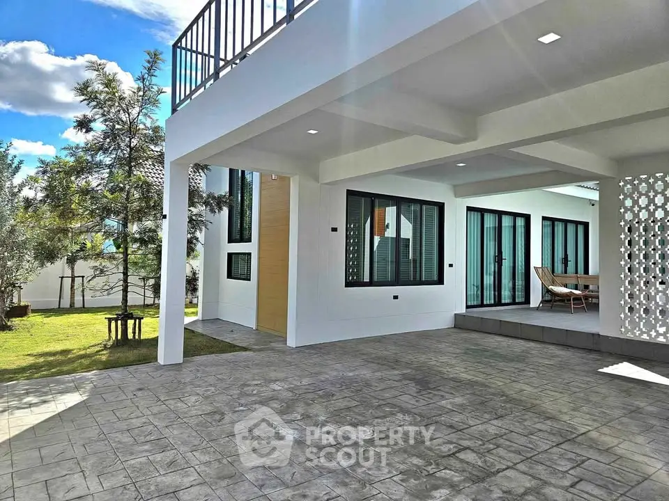 Modern home exterior with spacious patio and lush garden