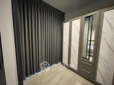 Elegant bedroom with luxurious wardrobe and floor-to-ceiling curtains
