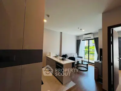 Modern living room with open kitchen and balcony view