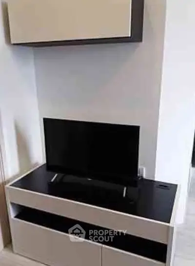 Modern living room with sleek TV stand and wall-mounted cabinet
