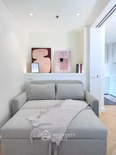 Modern living room with stylish sofa bed and elegant decor in a cozy apartment setting.