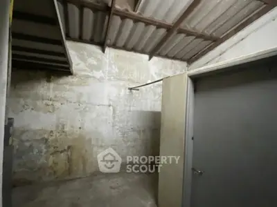 Spacious storage room with concrete walls and ceiling, ideal for extra storage needs.