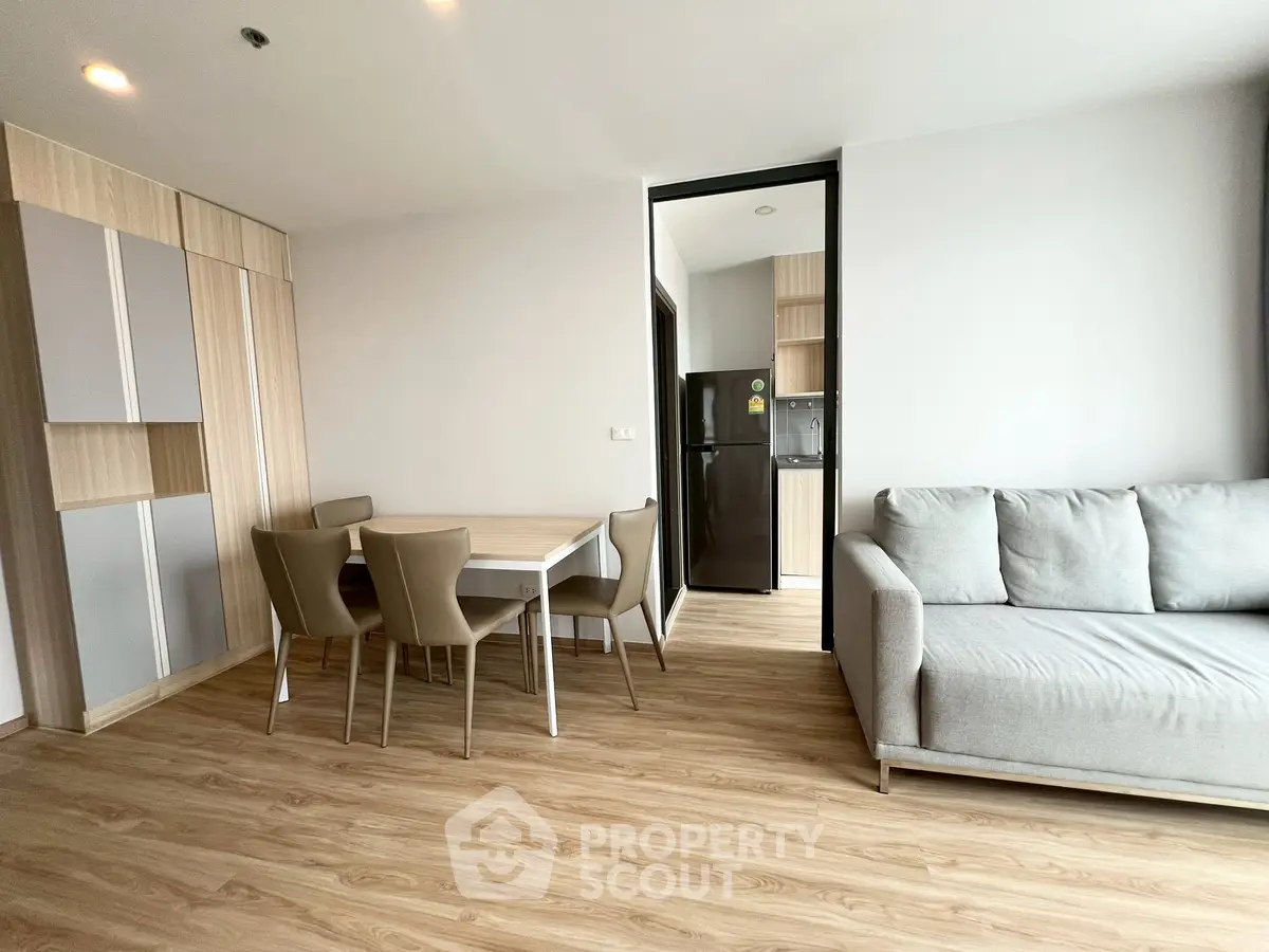 Modern living room with dining area and sleek kitchen in open layout apartment