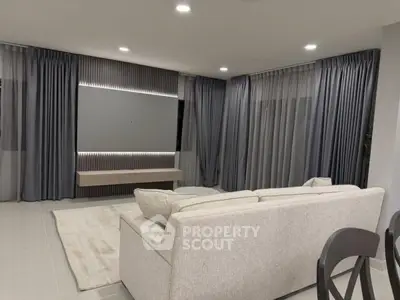 Spacious modern living room with elegant gray curtains and cozy beige sofa