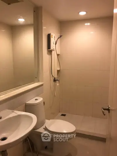 Modern bathroom with shower and toilet in a compact space