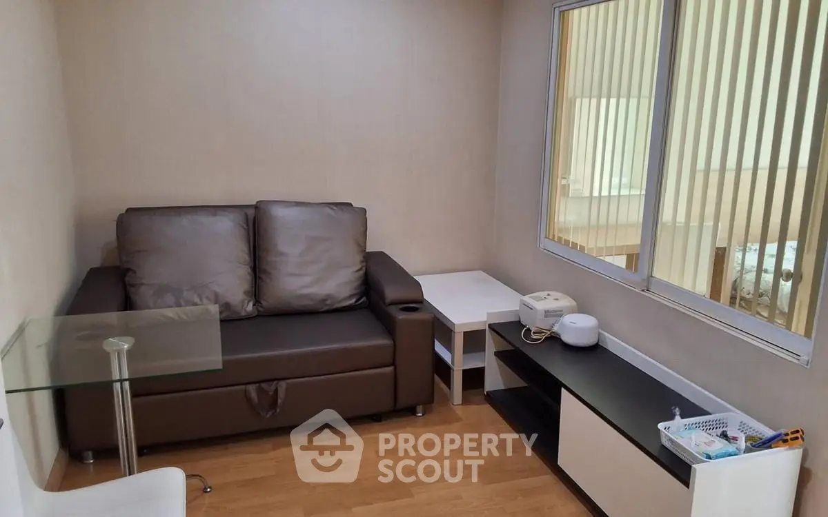 Cozy small living room with brown leather sofa and modern decor