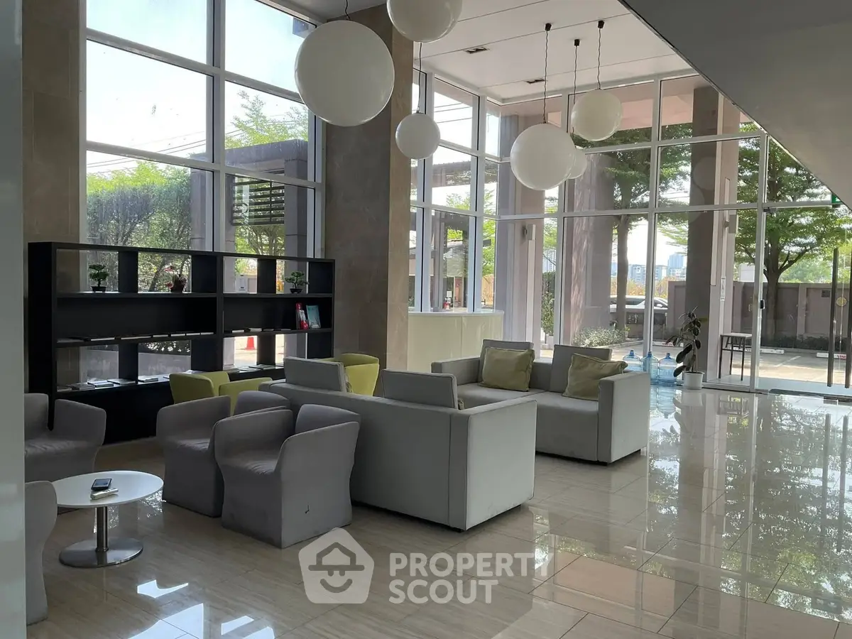 Modern lobby with stylish seating and large windows offering natural light.