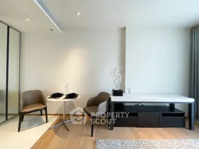 Modern living room with elegant dining setup and stylish furniture