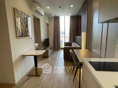 Modern living room with open kitchen in high-rise apartment, featuring sleek design and city view.