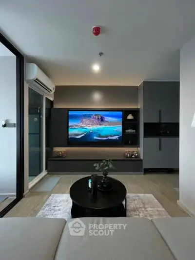 Modern living room with sleek design, featuring a wall-mounted TV and stylish furniture, perfect for urban living.