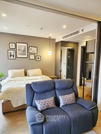 Modern bedroom with cozy seating and stylish decor