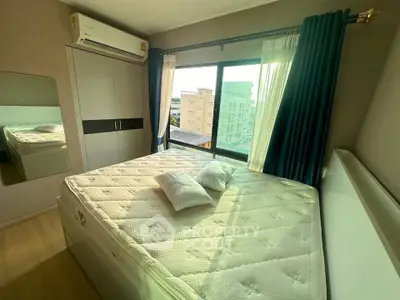 Bright bedroom with large window and modern furnishings