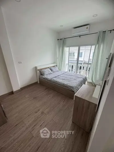 Modern bedroom with large window and minimalist decor