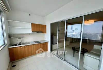 Modern kitchen with open layout and sliding glass doors to spacious living area.