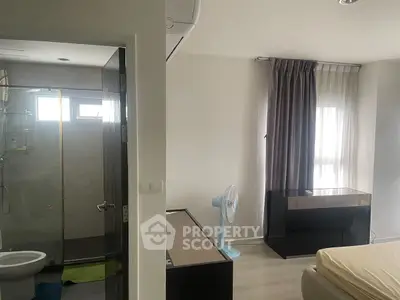 Modern bedroom with ensuite bathroom, featuring sleek design and natural light.