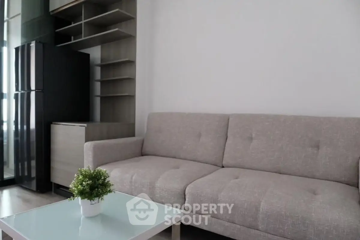 Modern living room with stylish sofa and sleek shelving, perfect for urban living.