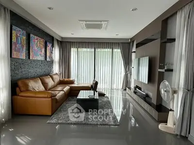 Luxurious living room with modern decor and large windows for natural light.