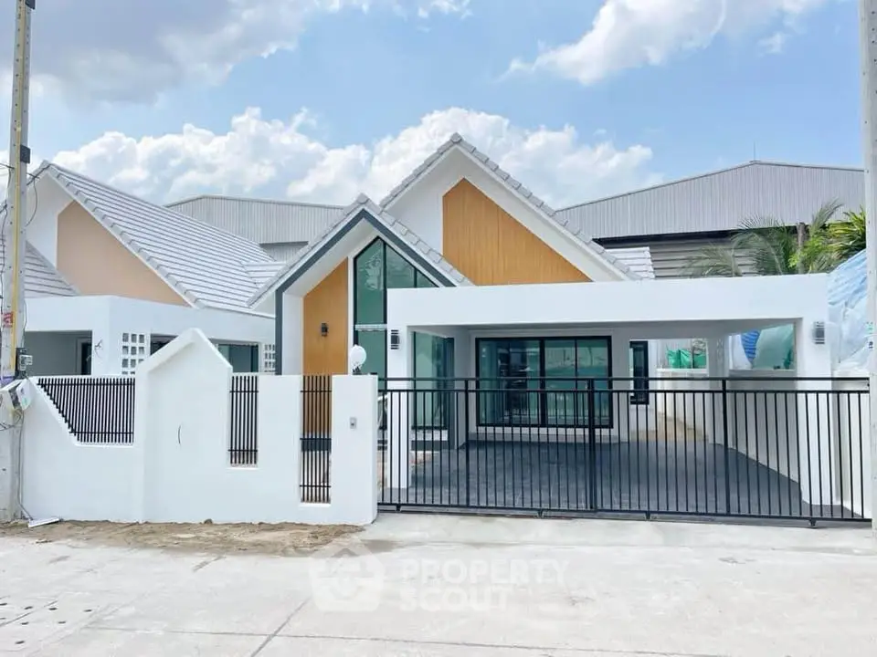 Modern single-story house with unique roof design and spacious driveway