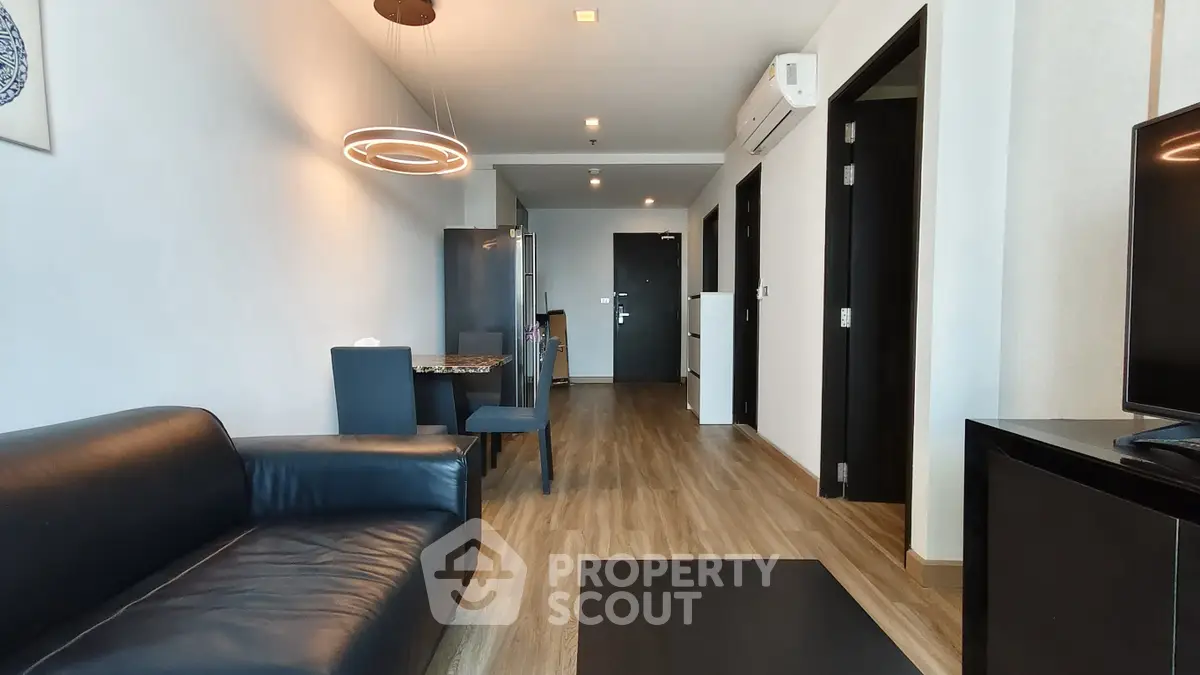 Modern living room with sleek furniture and stylish lighting in a contemporary apartment.